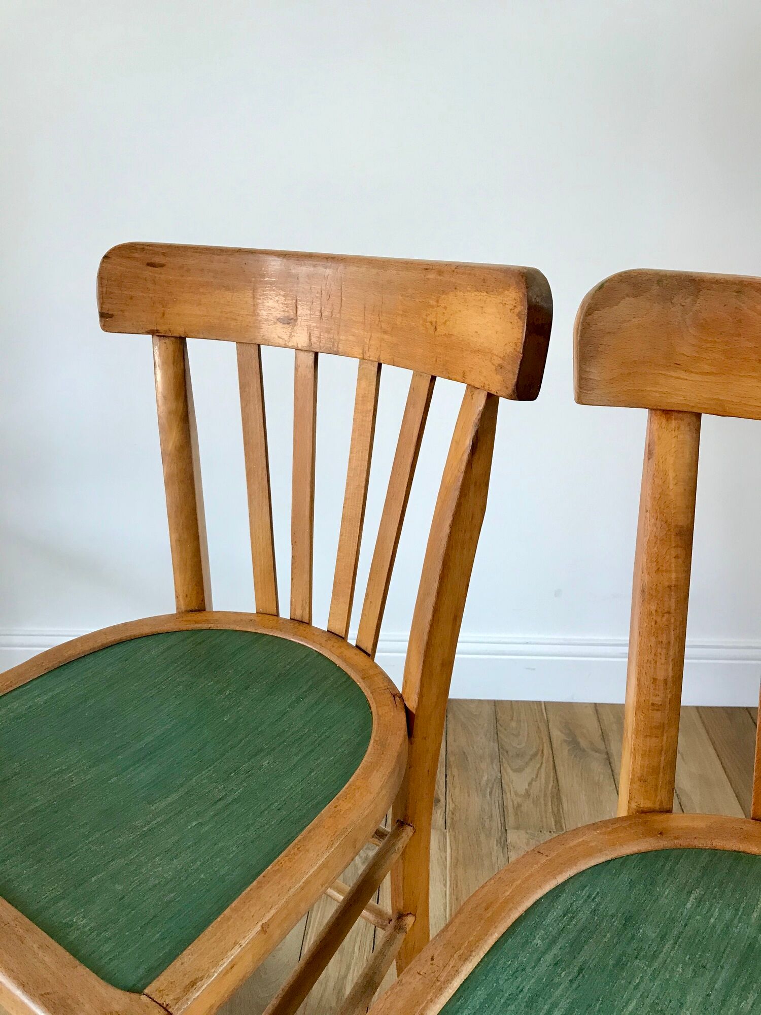 Pair of bistro chairs in light curved wood and green seat 1950s