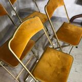 Four folding velvet and brass chairs