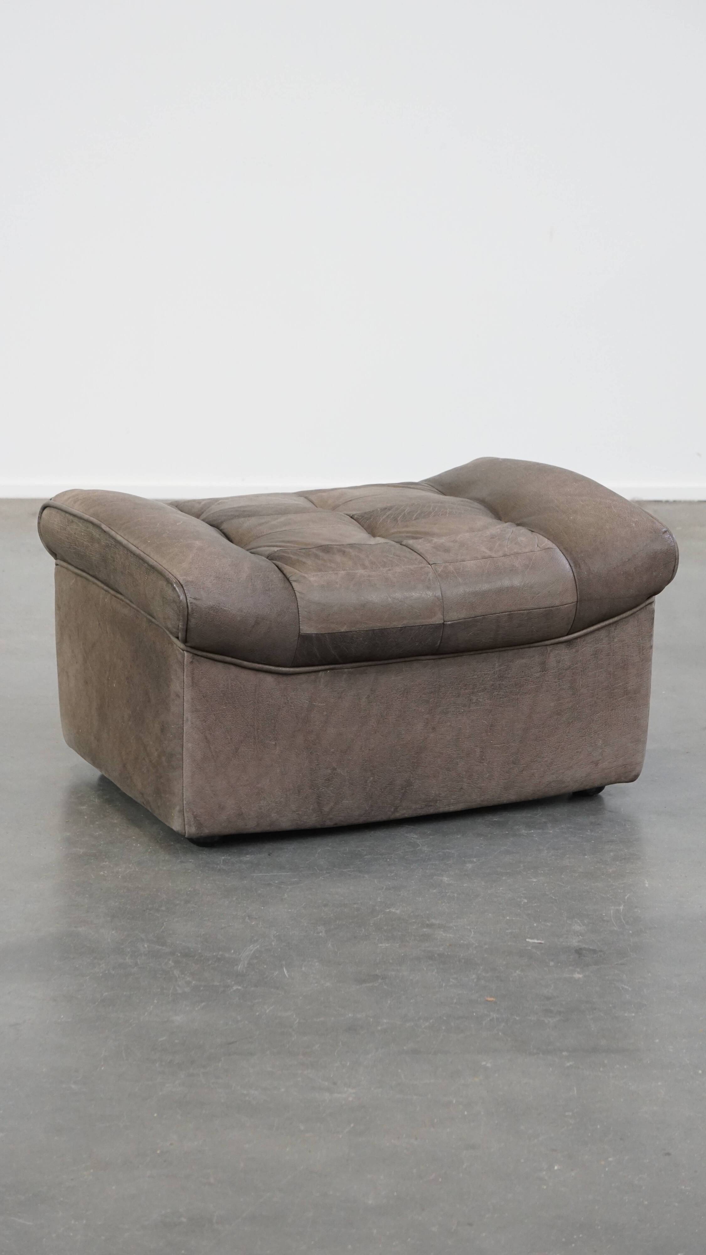 Luxurious, comfortable, gray leather vintage footstool