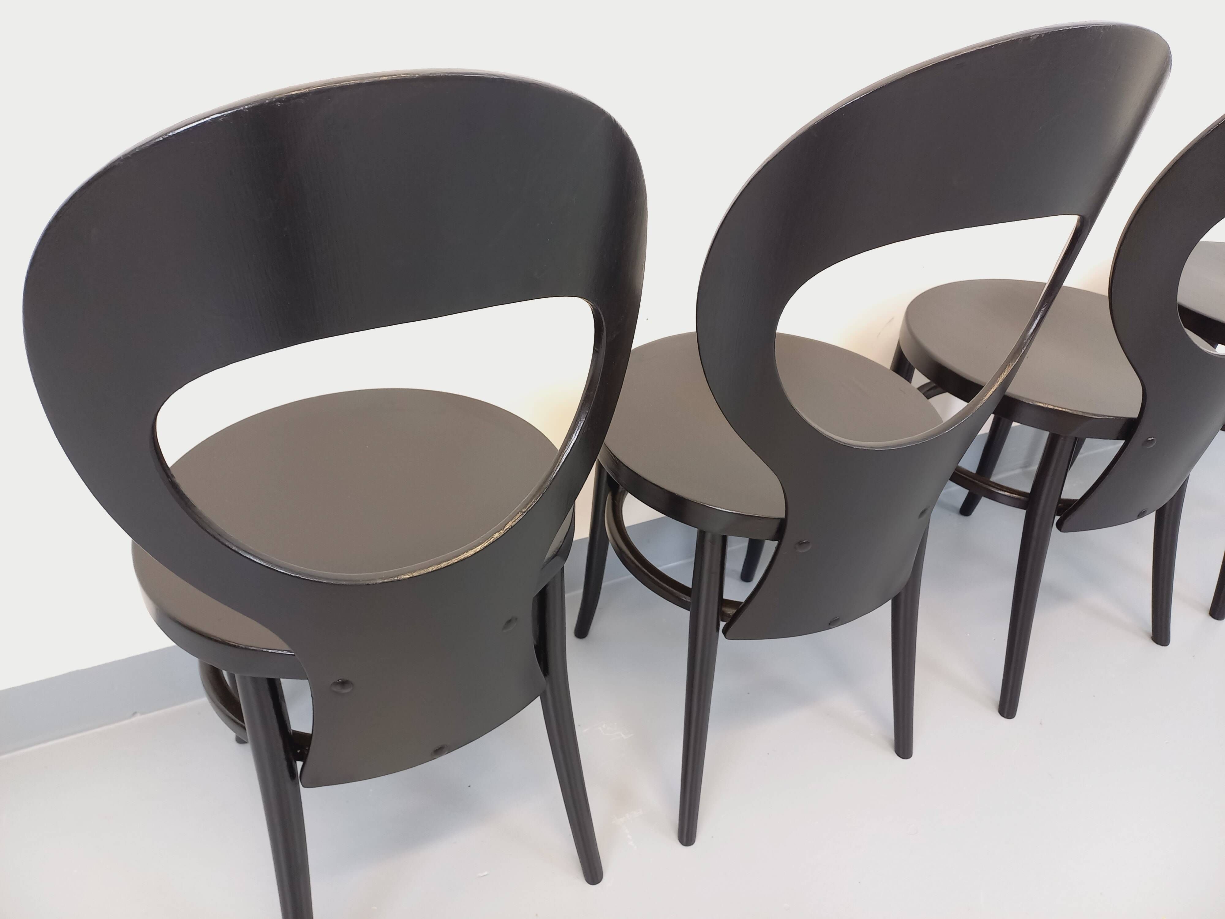 Set of 4 vintage Mouette chairs by Baumann in black wood from the 1960s.