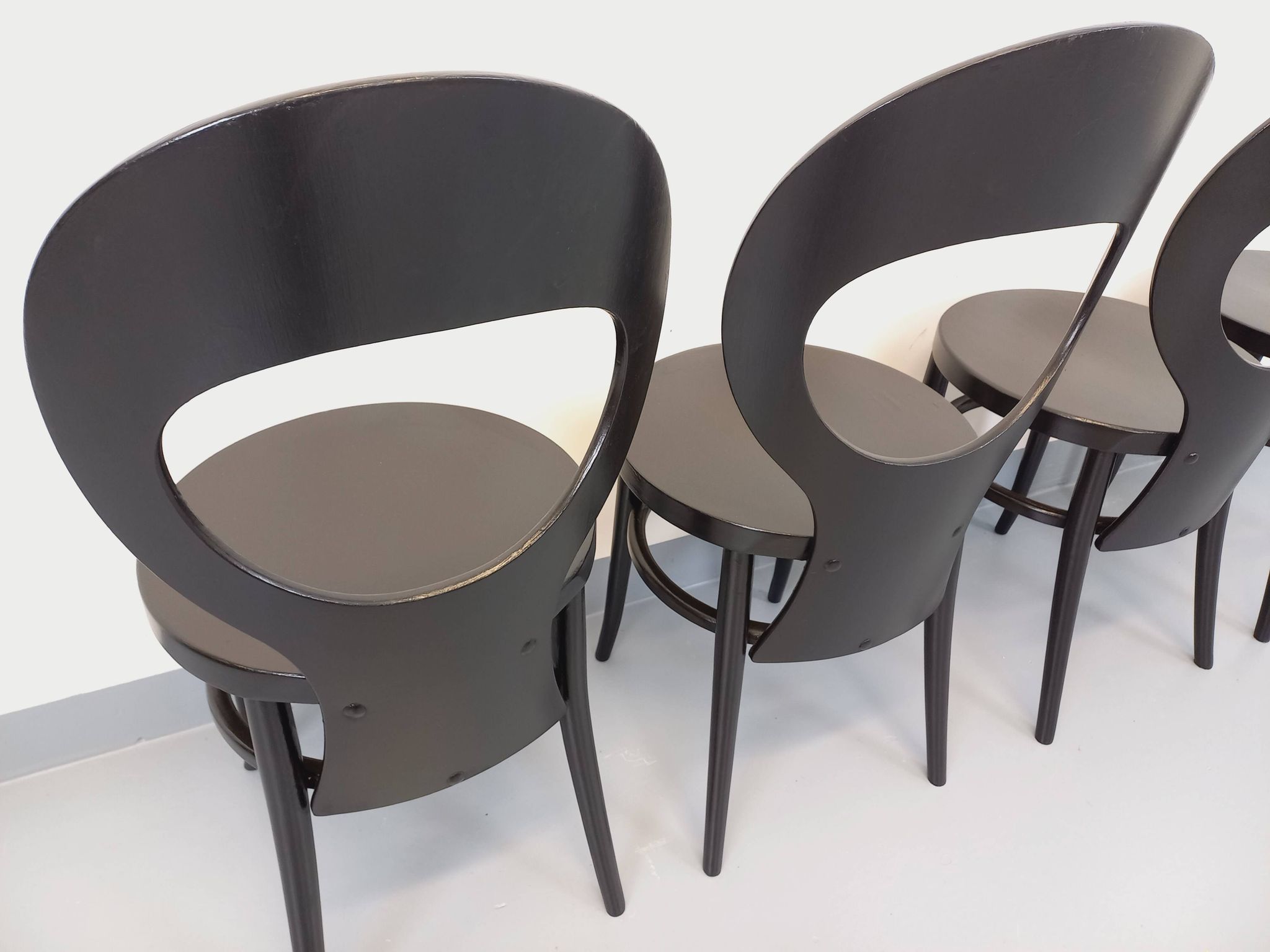 Set of 4 vintage Mouette chairs by Baumann in black wood from the 1960s.