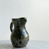 Small handcrafted ceramic pitcher with spotted enamel