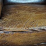 Dark wingback armchair made of sheep leather with stunning colors