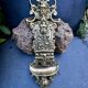 Brass magazine rack with baroque mask, wall-mounted match holder.