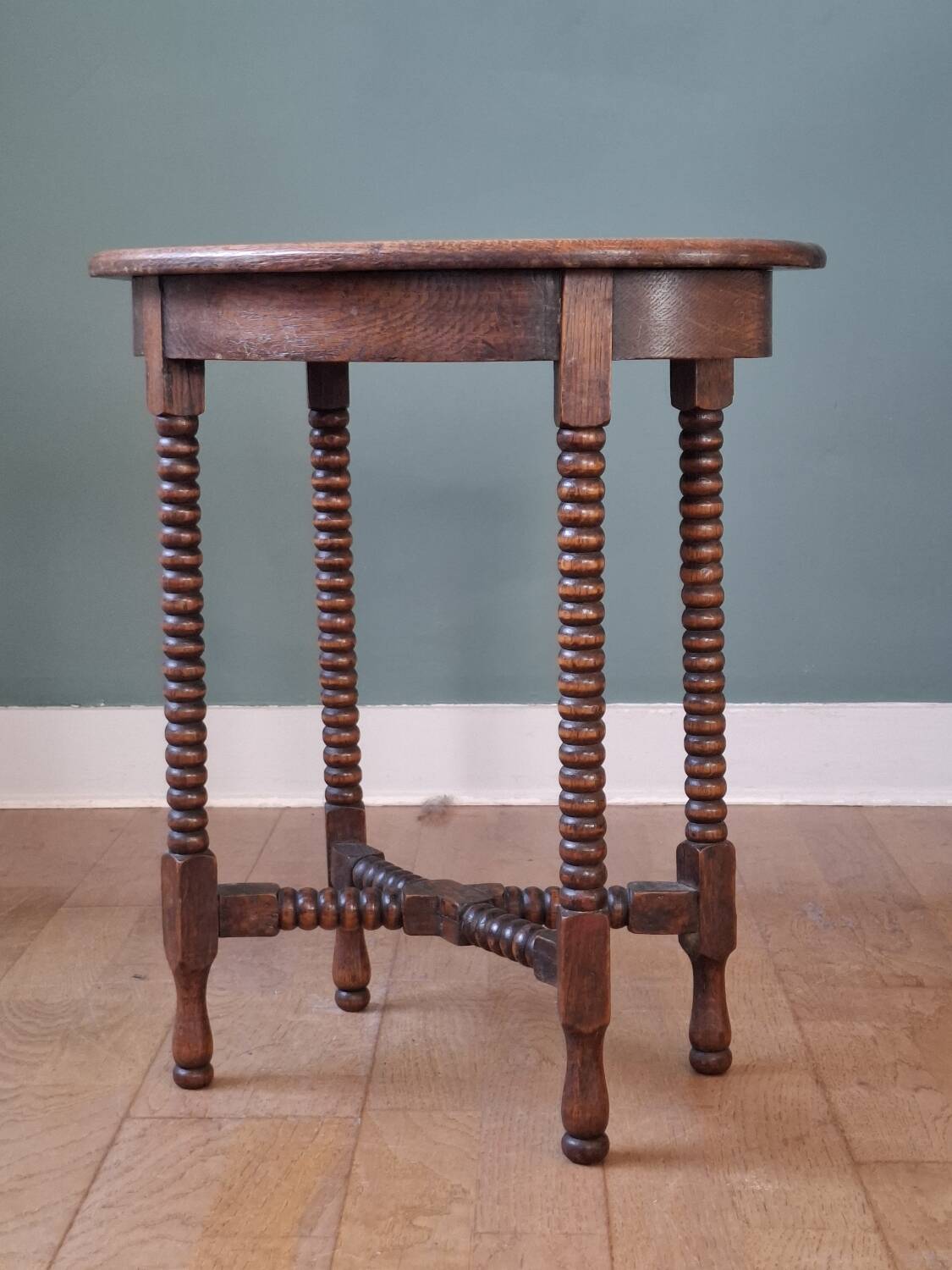Candle holder side table with spool legs