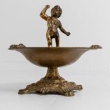 Vintage brass ashtray from the 1940s with a nude boy figurine on a footed base.