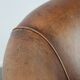 Club chair made of sheepskin leather finished with decorative nails