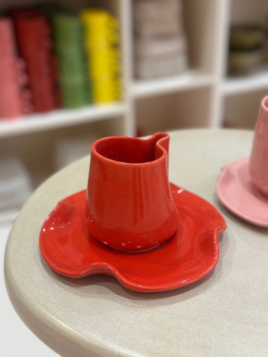 Set of ceramic artisan mugs with poppy red water lily design.