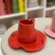 Set of ceramic artisan mugs with poppy red water lily design.