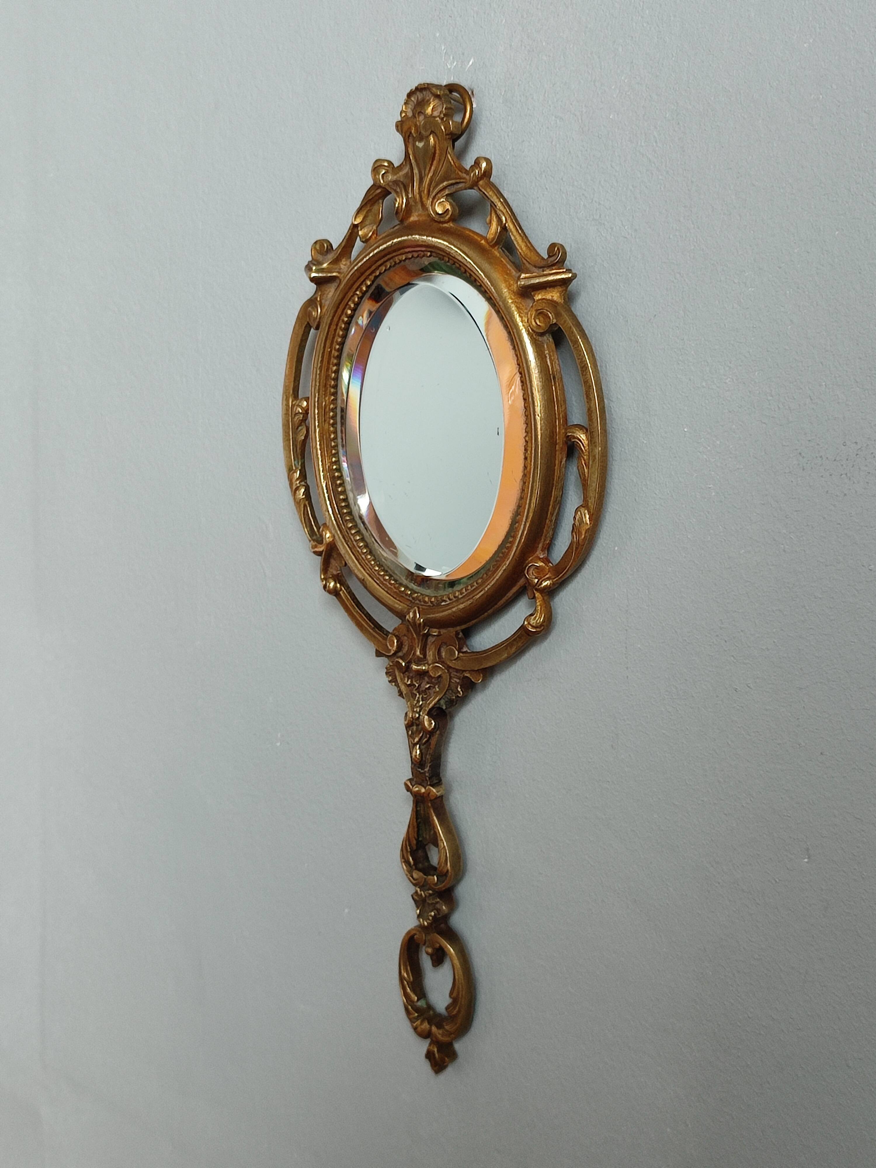 Antique hand-facing mirror in bronze and beveled glass