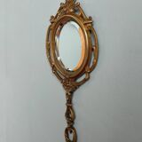 Antique hand-facing mirror in bronze and beveled glass