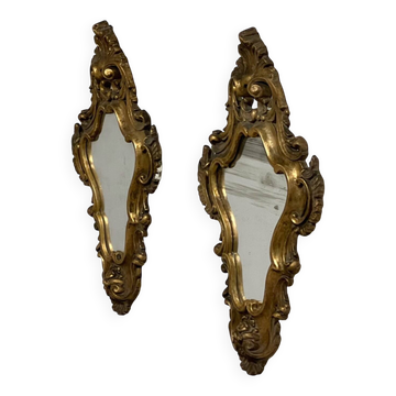 Pair of mirrors in wood decorated with gold leaf.