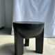 Black mango wood tripod side table with a semi-spherical top, height: 45 cm, diameter: 44 cm.