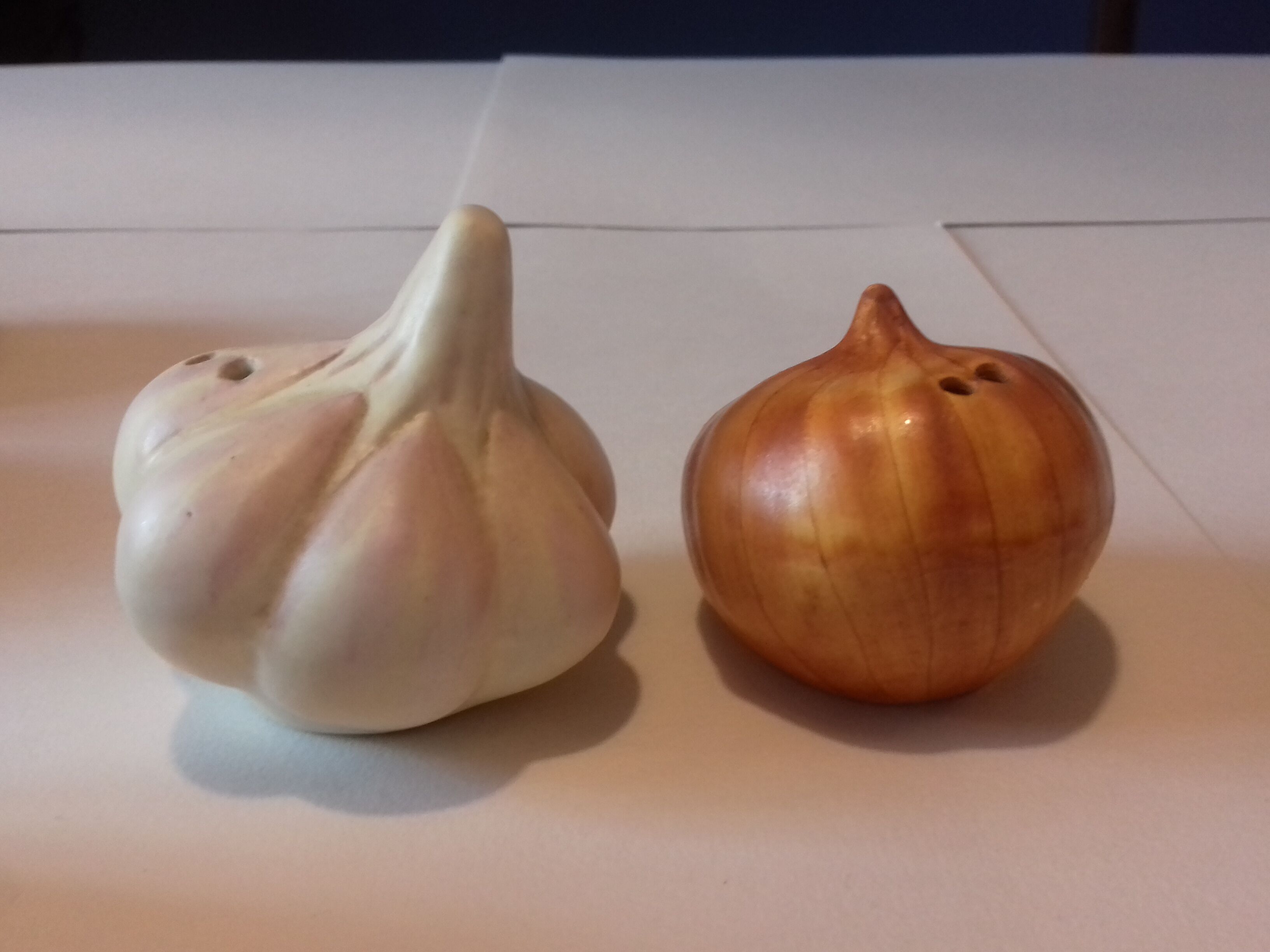 Pepper salt shaker in the shape of garlic and onion head