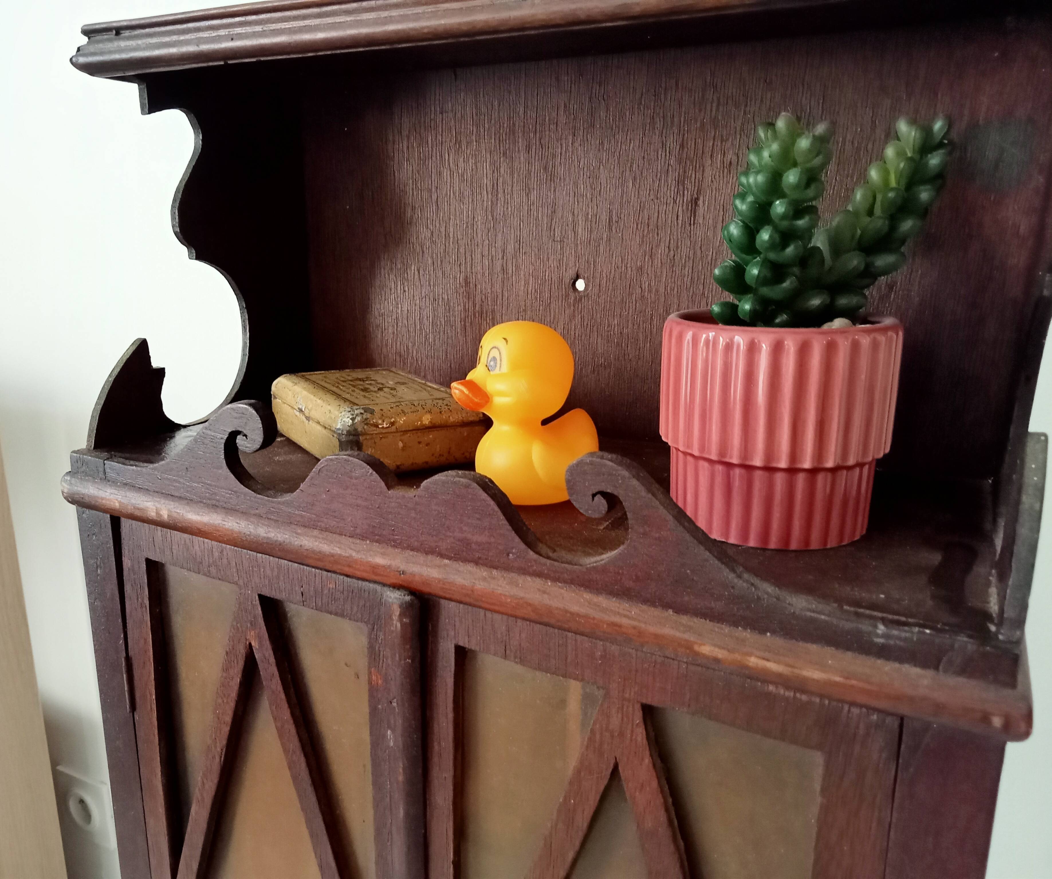 Small antique wall cabinet in Gothic style.