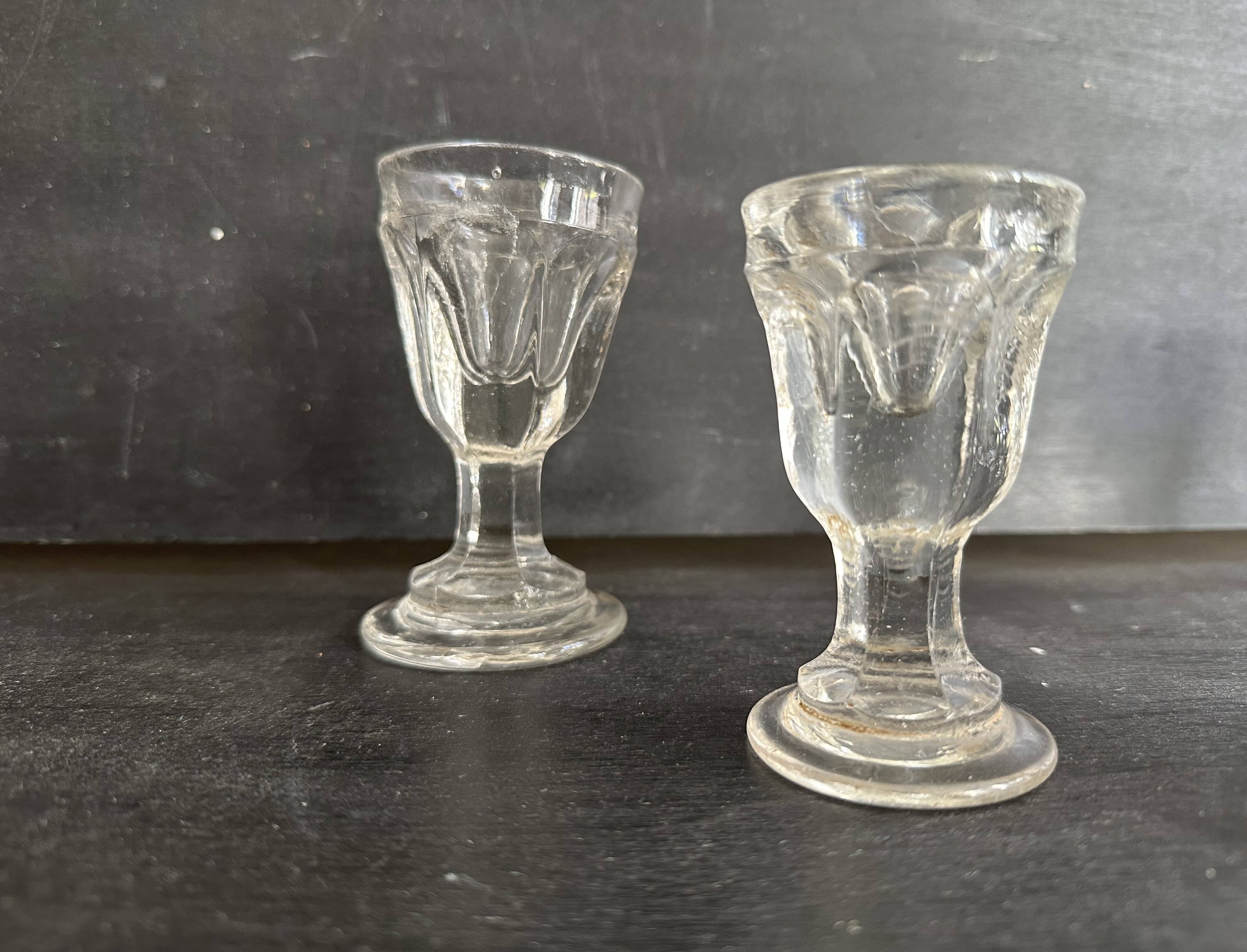Set of antique liqueur glasses in thick glass, bistro style.