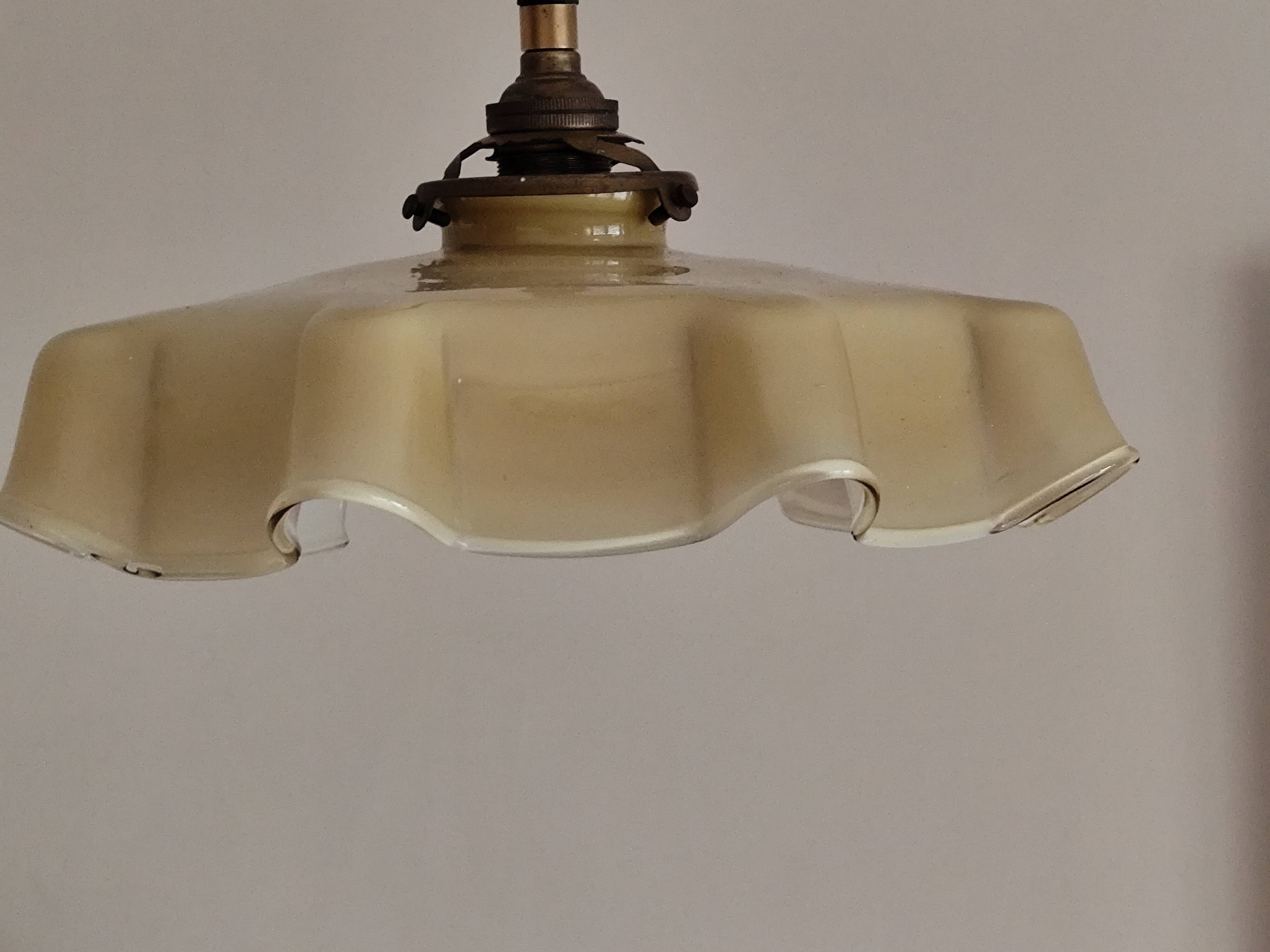 Electrified suspension with a frosted opaque glass disc shade.