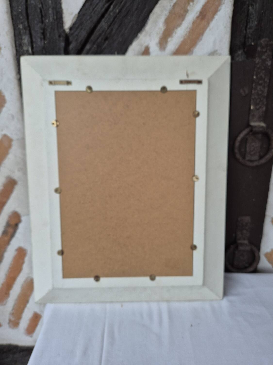 Oval mirror with a distressed white frame