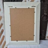 Oval mirror with a distressed white frame