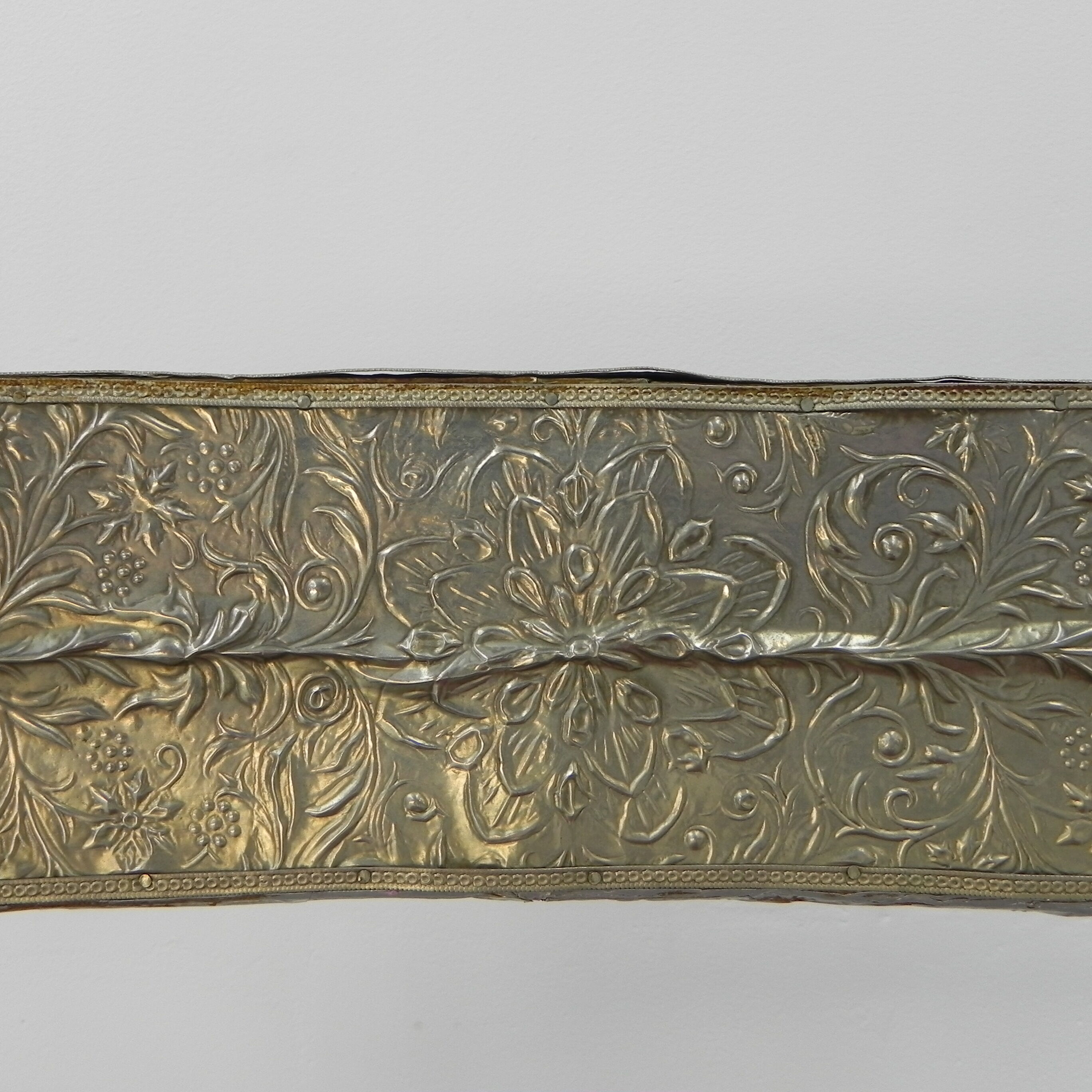 Dining chair upholstered with stamped tin