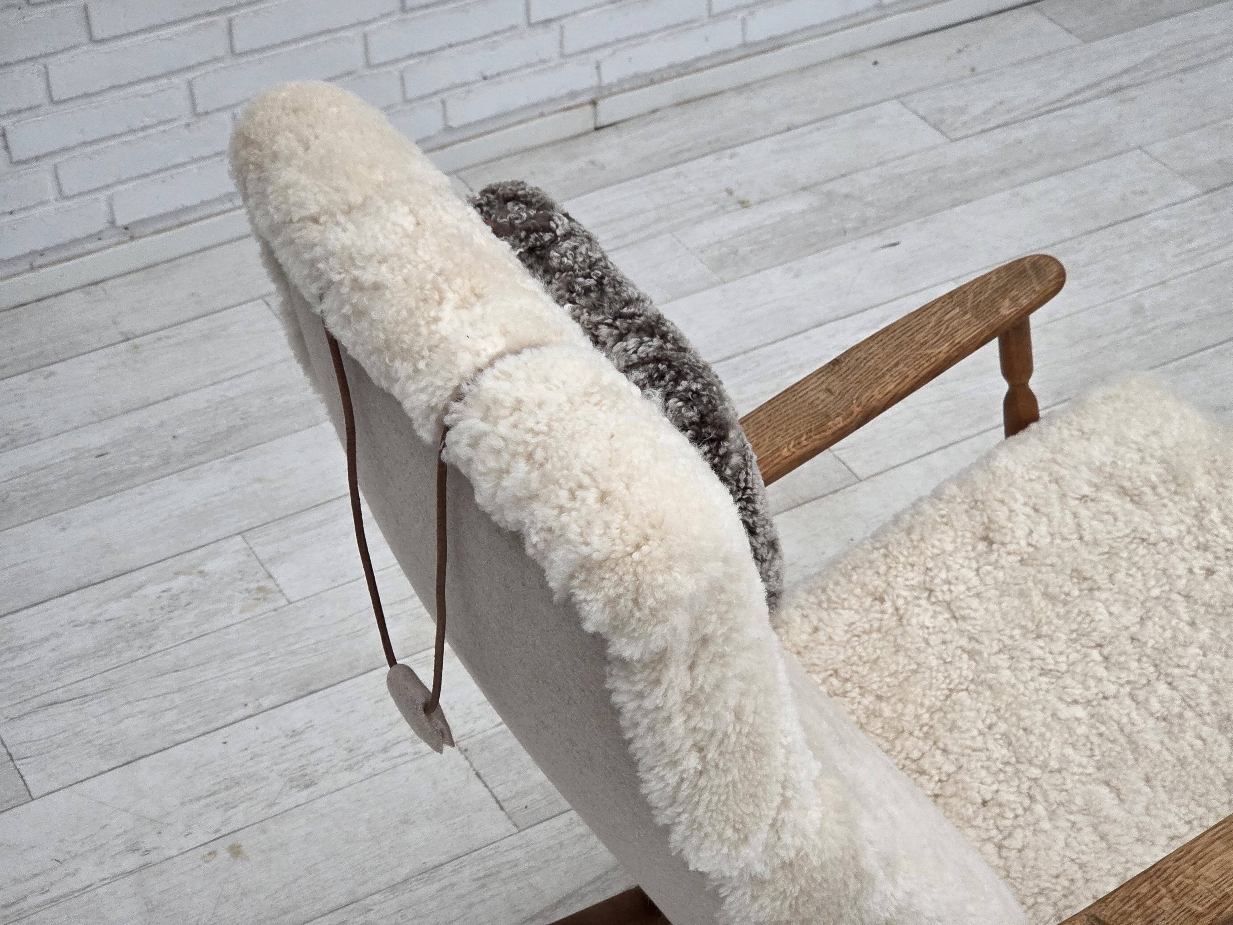 1970s, Danish rocking chair, reupholstered in quality genuine sheepskin.