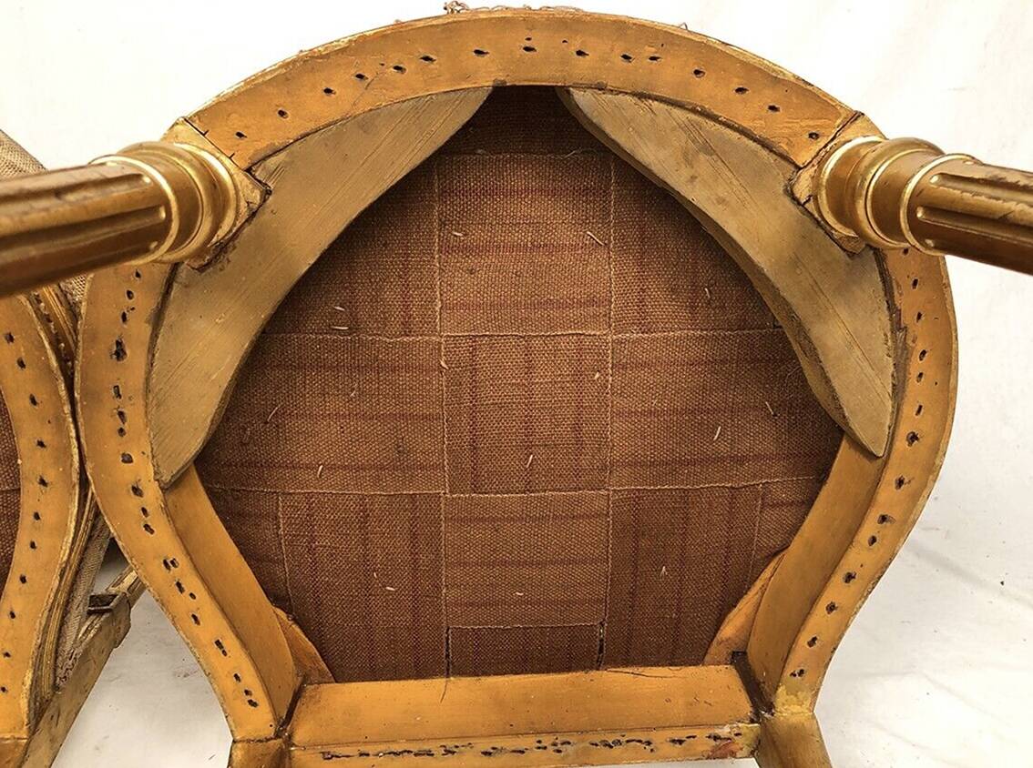 Series of three Louis XVI style chairs in gilded wood, circa 1900