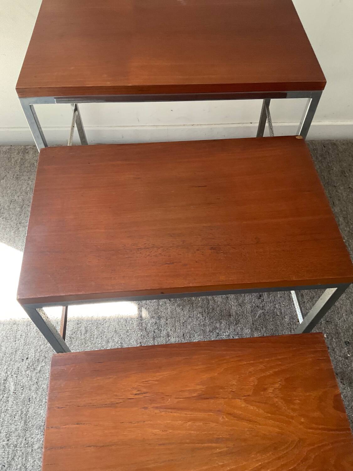 Trio of teak and chrome metal nesting tables from the 60s-70s