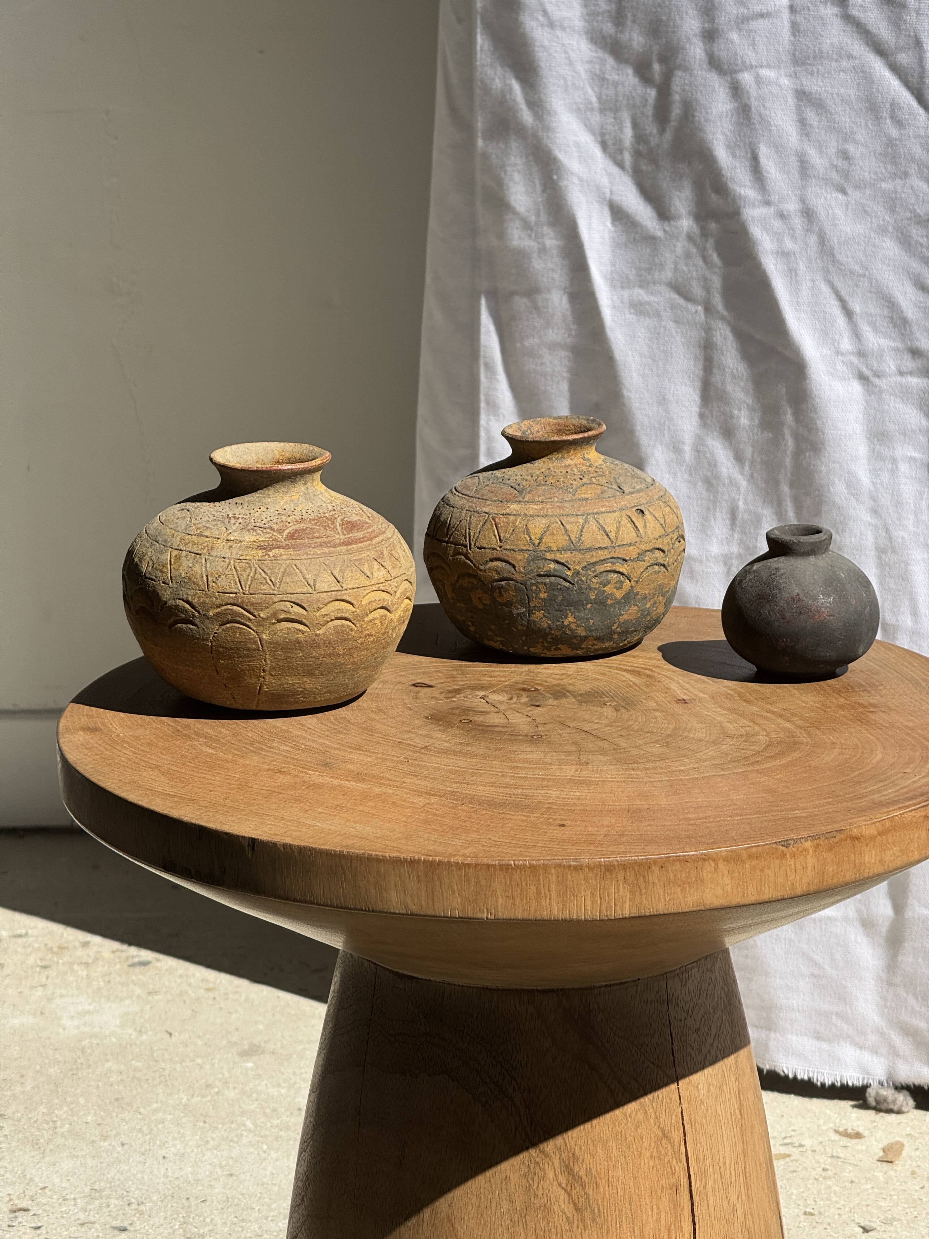 Natural solid mango side table (monoxyle) with conical legs.