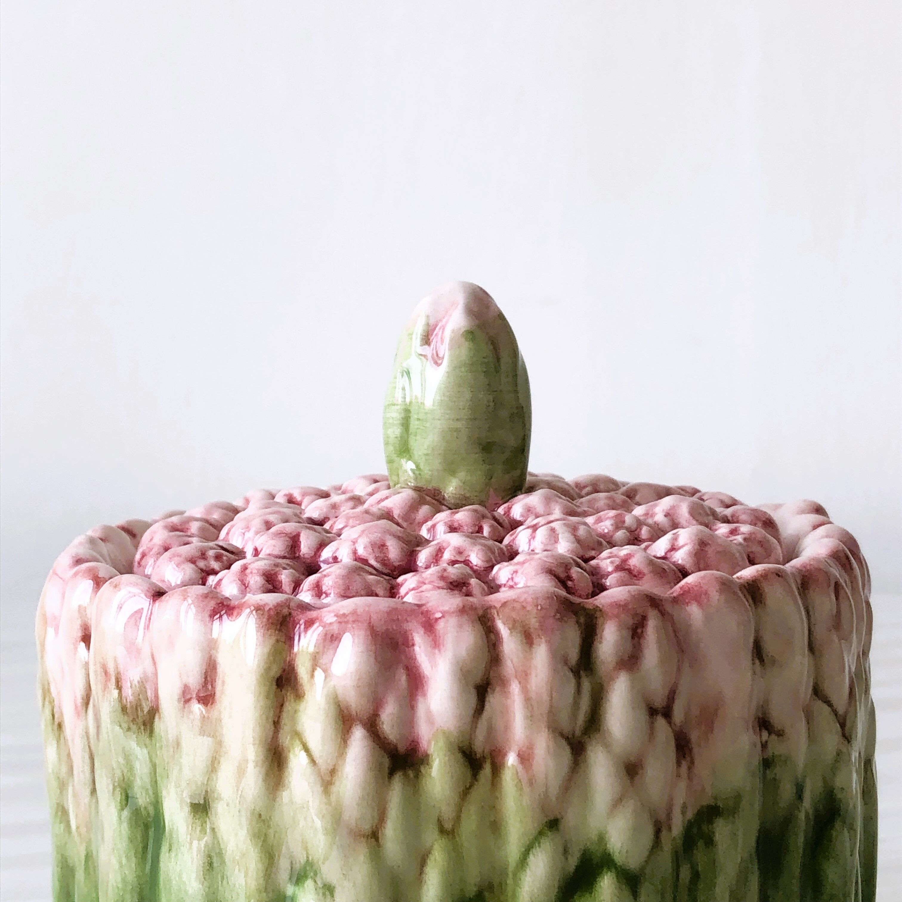 Old mustard pot and its slid in slurry decoration bunch of asparagus.