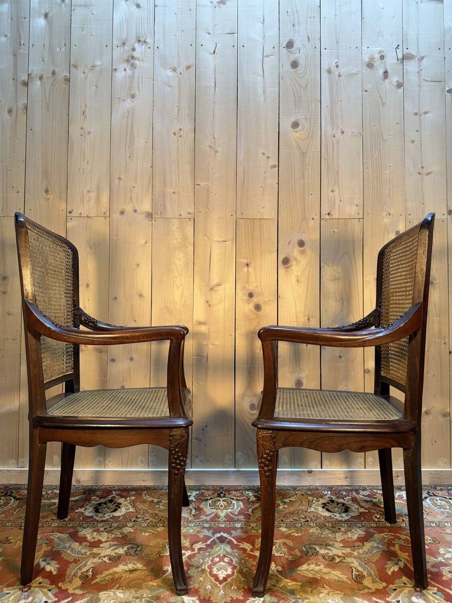 Pair of wide caned armchairs from the Art Nouveau period.
