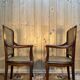 Pair of wide caned armchairs from the Art Nouveau period.