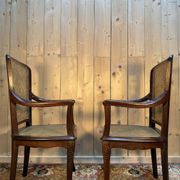 Pair of wide caned armchairs from the Art Nouveau period.