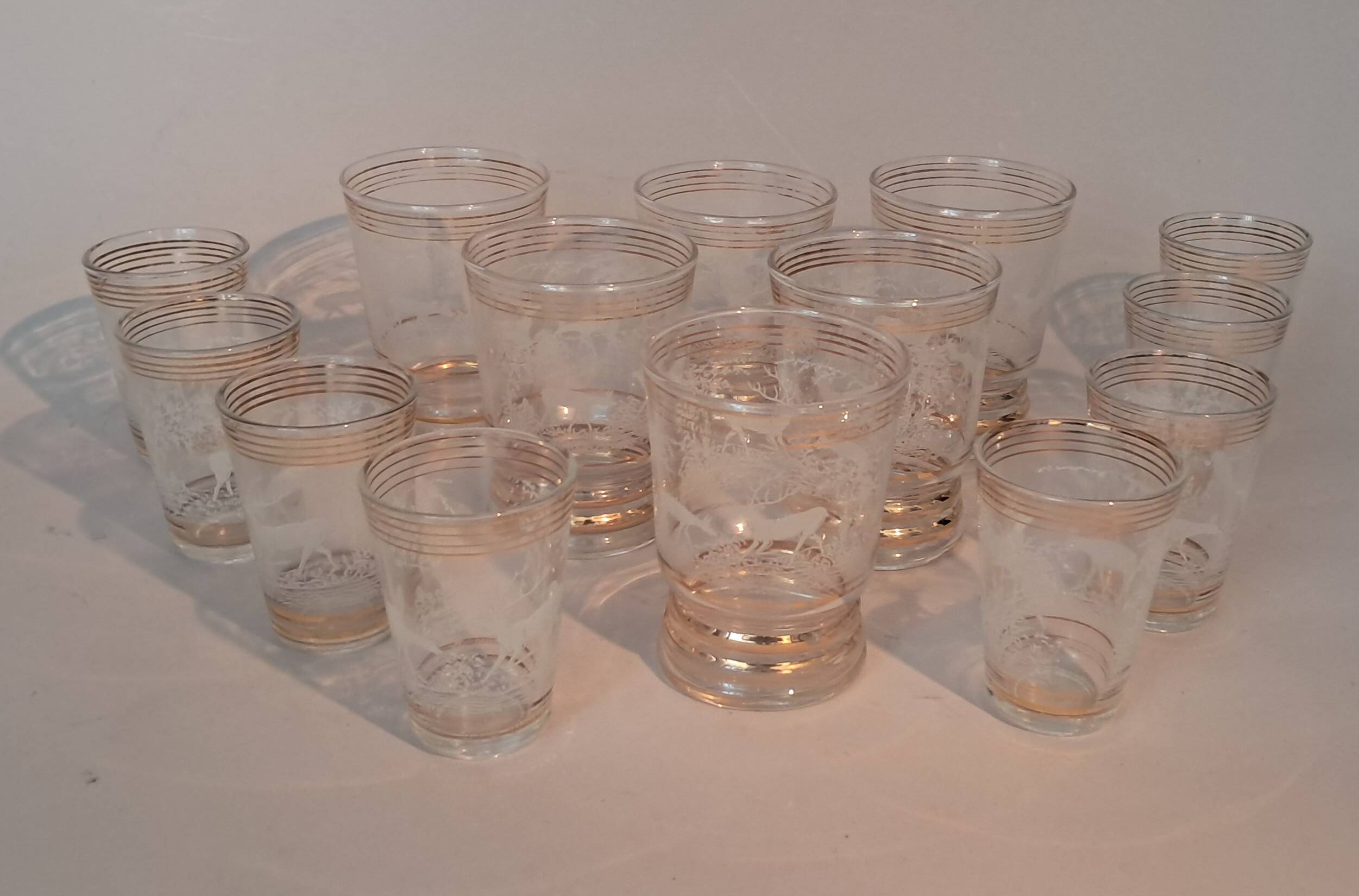 Service of 14 gold-plated and engraved glasses with a deer in the woods design from 1950