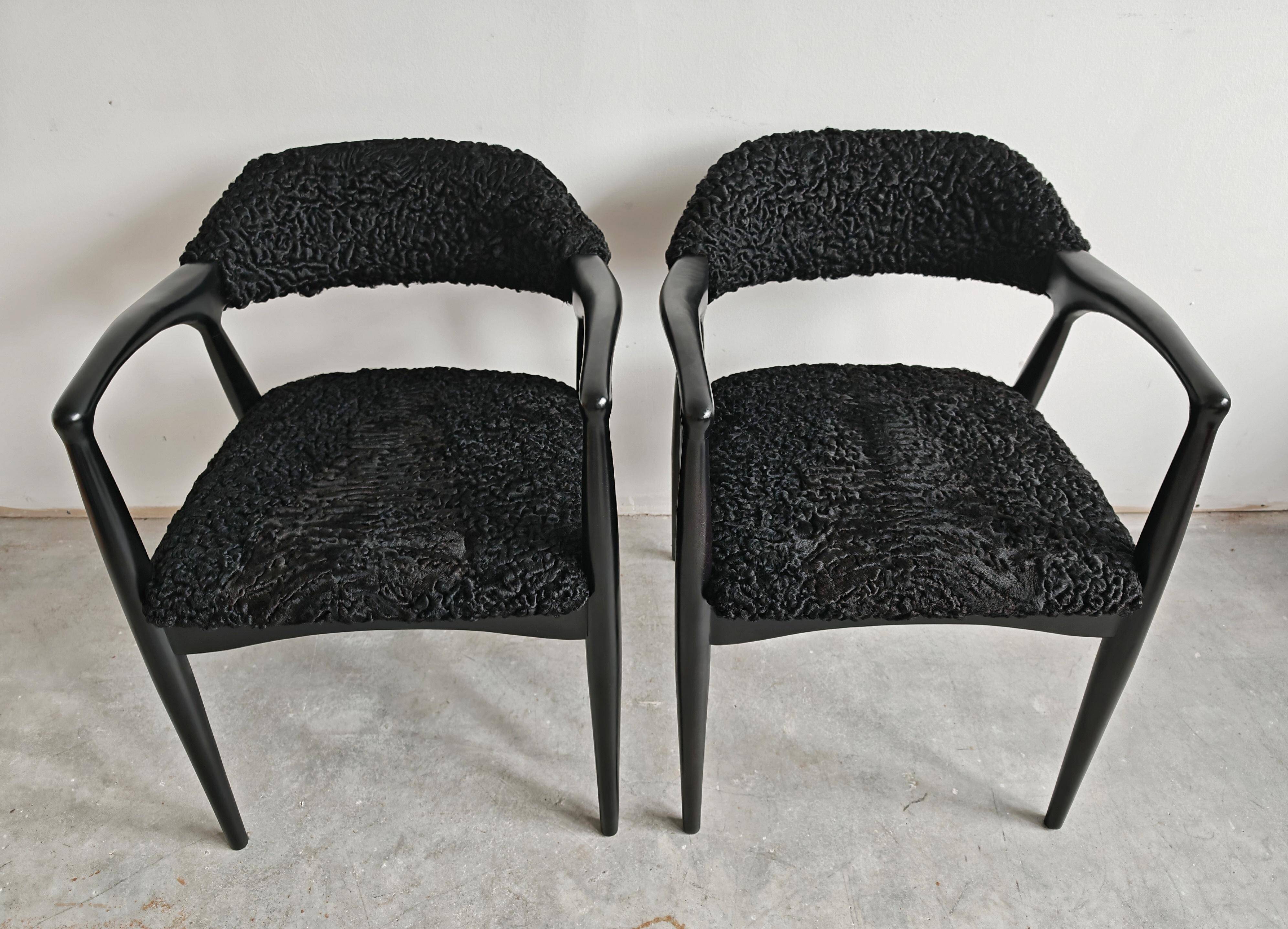 Pair of Mid Century Modern armchairs in astrakhan leather.