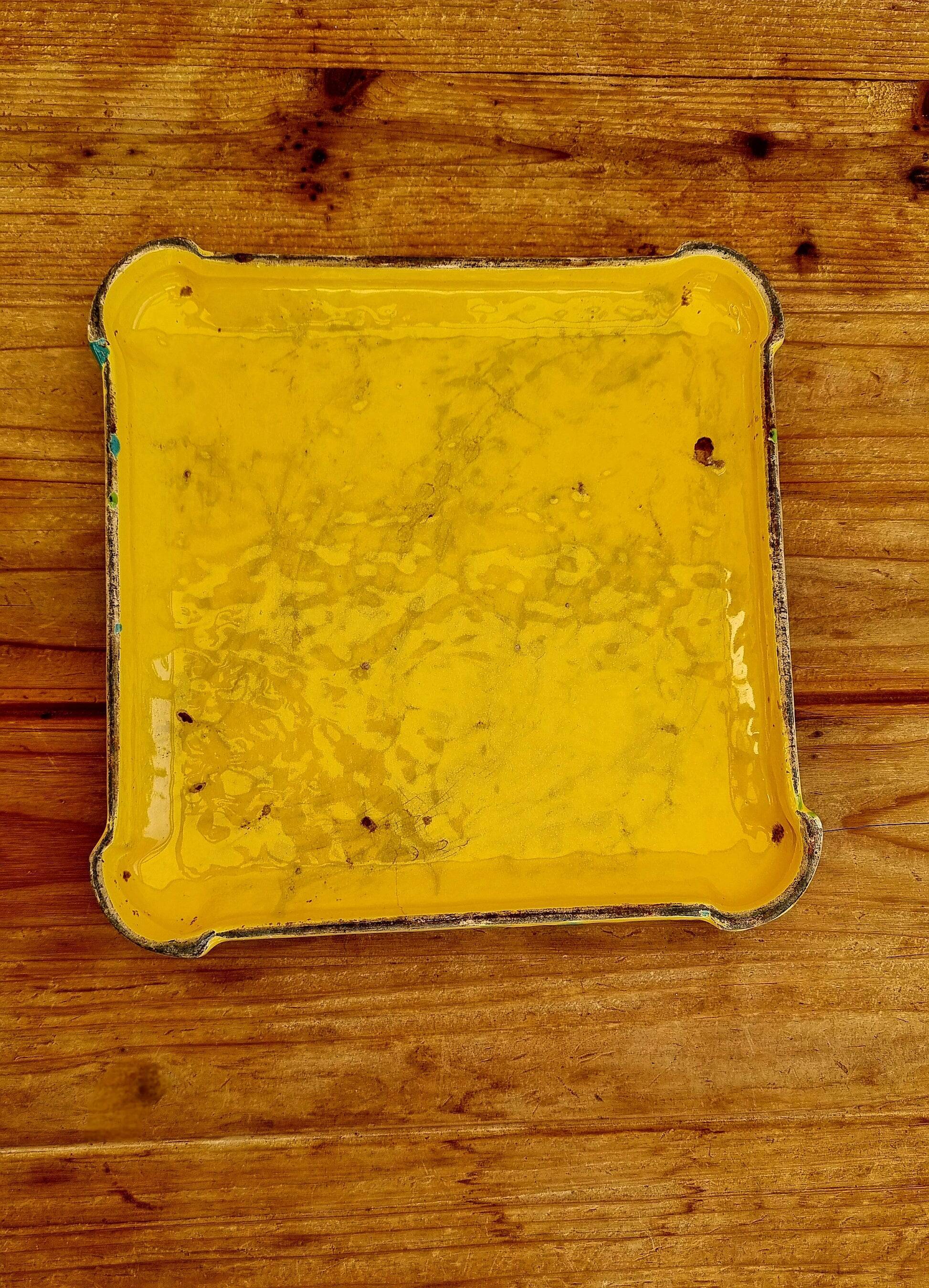 Yellow ceramic trivet and bottle coaster with vintage painted decoration.