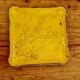 Yellow ceramic trivet and bottle coaster with vintage painted decoration.