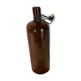 Old bottle in sandstone with a mechanical porcelein cap