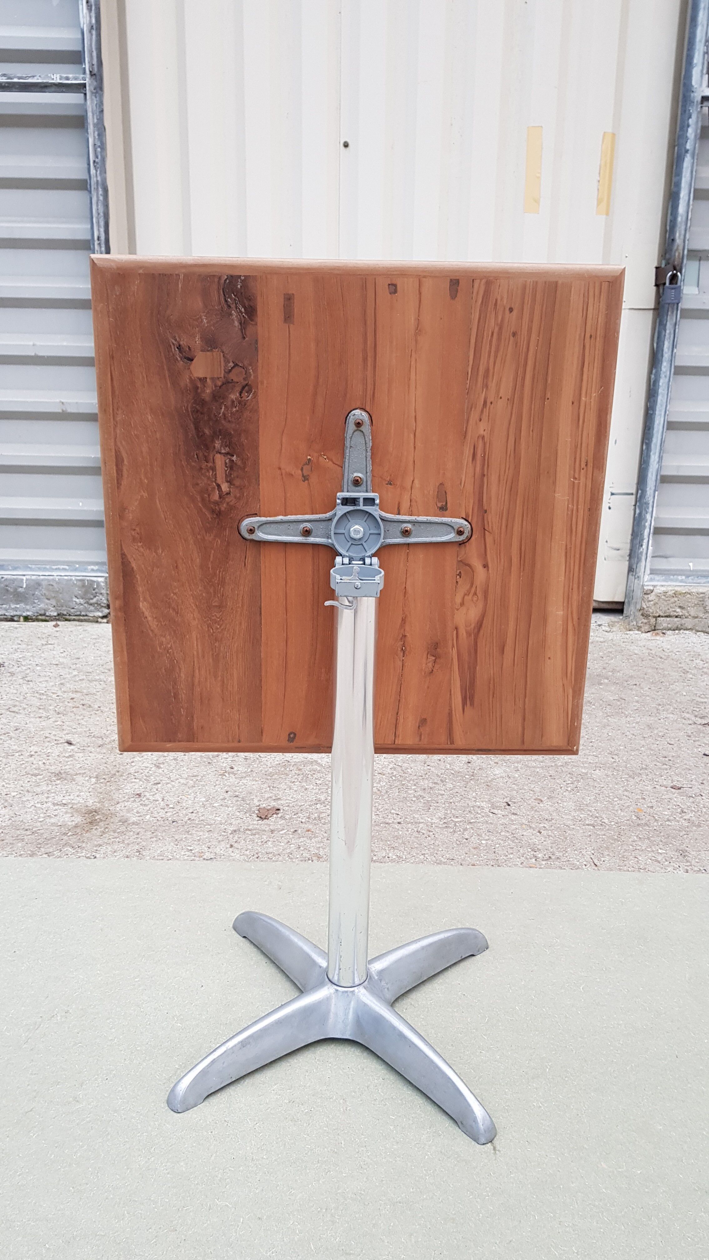 Foldable bistro table with teak top and aluminum base