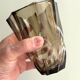 Small translucent dark brown twisted glass vase