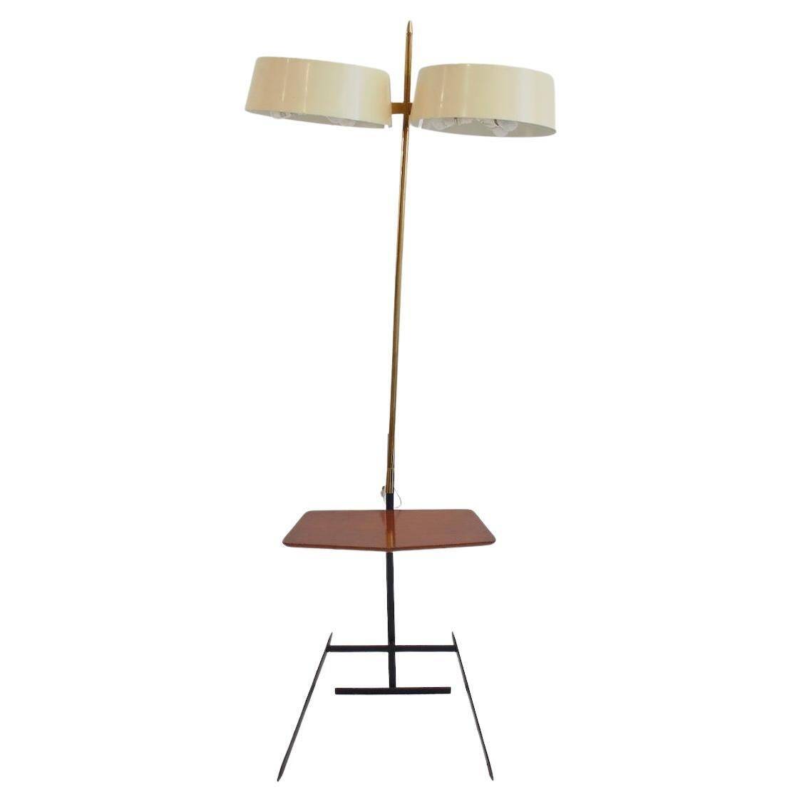 Brass and lacquered metal floor lamp with a wooden magazine shelf.