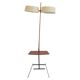 Brass and lacquered metal floor lamp with a wooden magazine shelf.