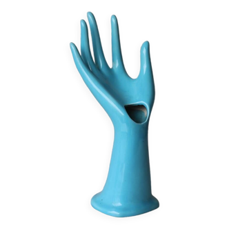 Hand holds blue jewelry, ring sizer, soliflore, vintage