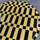Round coffee table in yellow and black zellige, Moroccan graphic pattern.