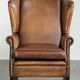 Sheepskin wingback armchair with patina finished with decorative nails