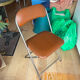 Brown folding chair in vinyl and steel