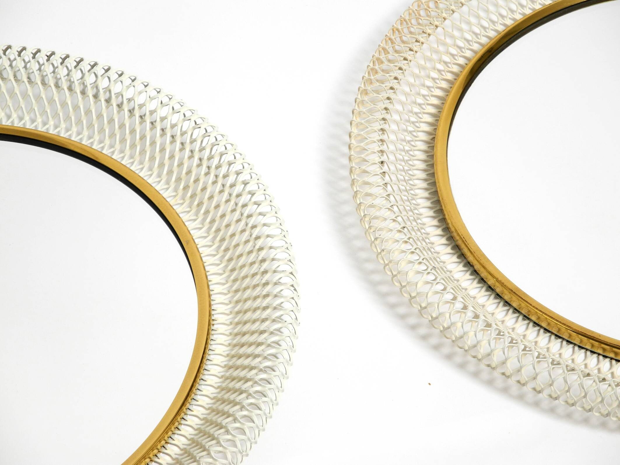 Pair of Mid Century wall mirrors with brass rim and white metal frames