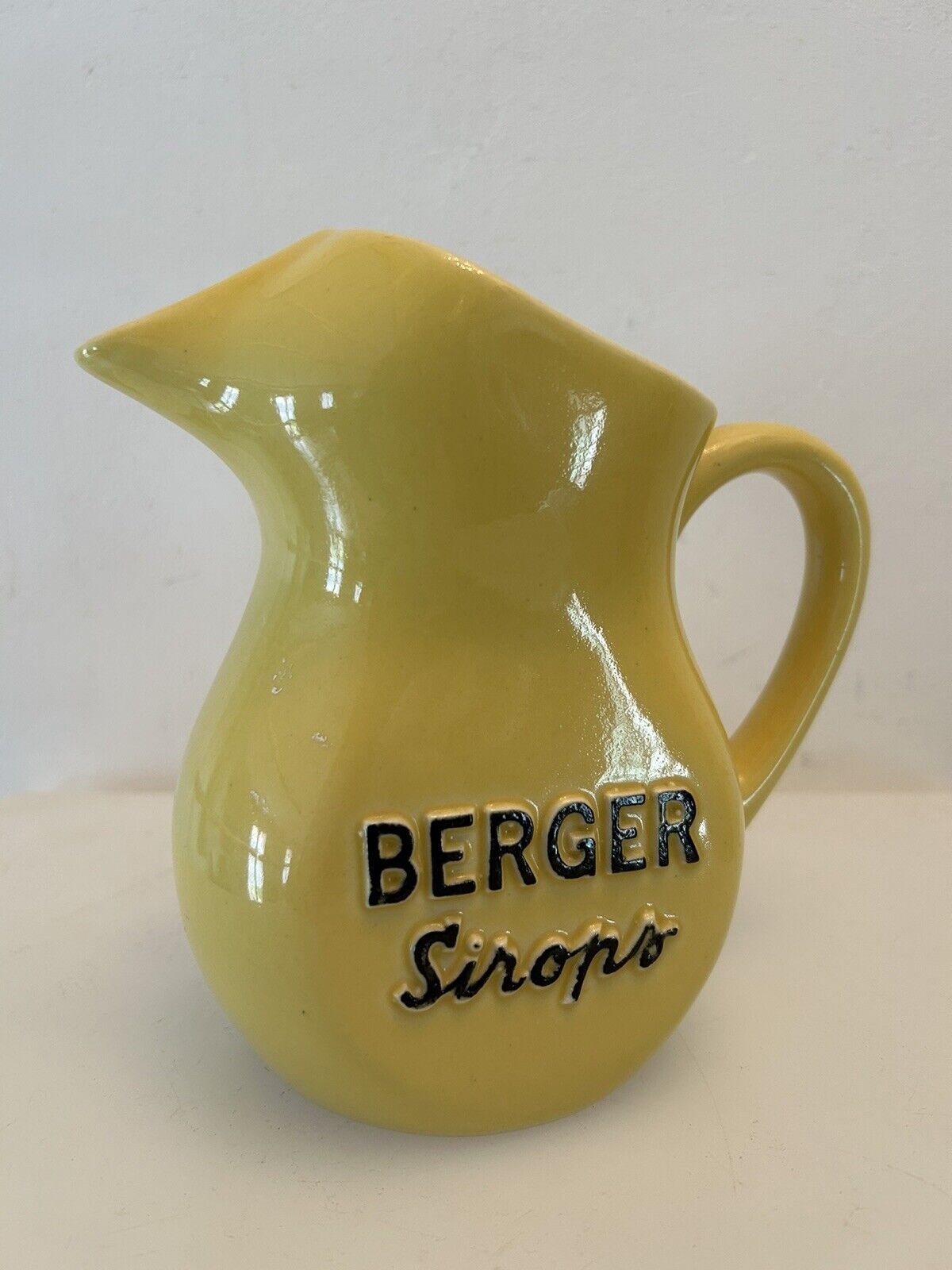 Old yellow pitcher anisette berger syrups, vintage bistro decoration
