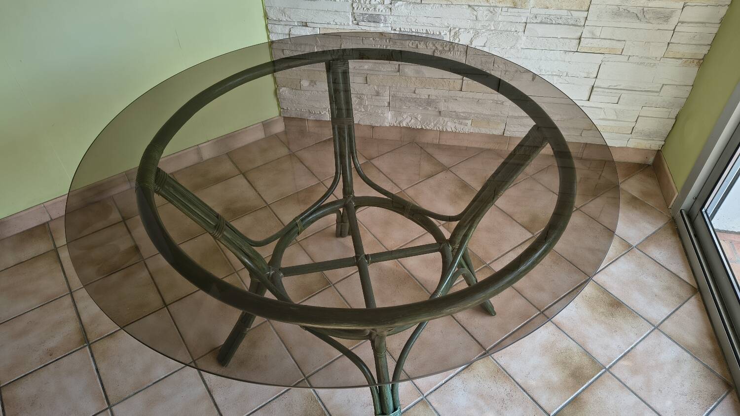 Round bamboo rattan table with a glass top.