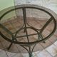 Round bamboo rattan table with a glass top.