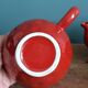 Teapot and cup in the shape of a strawberry.
